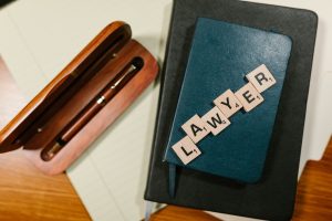 a pen and a notebook with the word "lawyer"