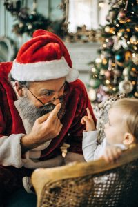 a Santa Claus and a child in mall