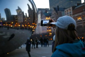 a woman taking photo of the Bean