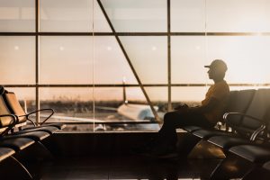 a man sitting on a chair at an airport