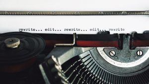 a typewriter typing "rewrite...edit..."