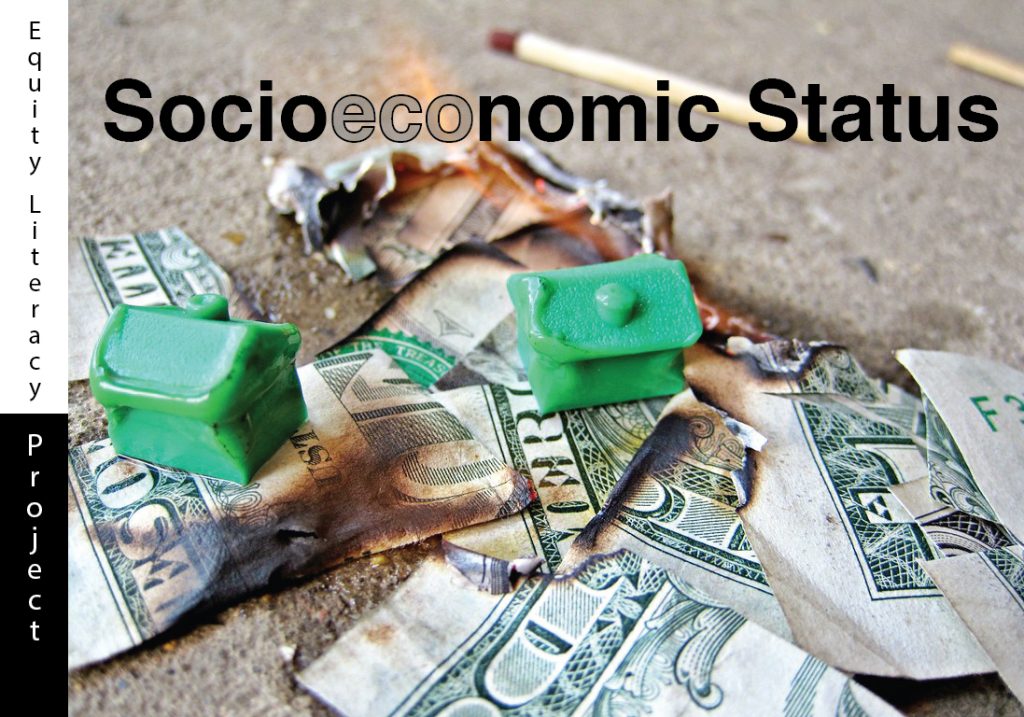 A stack of one-dollar bills and green plastic board game houses being burned by fire on a pavement ground. The green houses resemble that of the board game Monopoly. There are two matches in the distance and out of focus. The words Socioeconomic Status captioned at the top with the flame from the burning material being visible through the text.