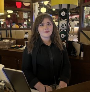 Harper graduate working as hostess at local venue